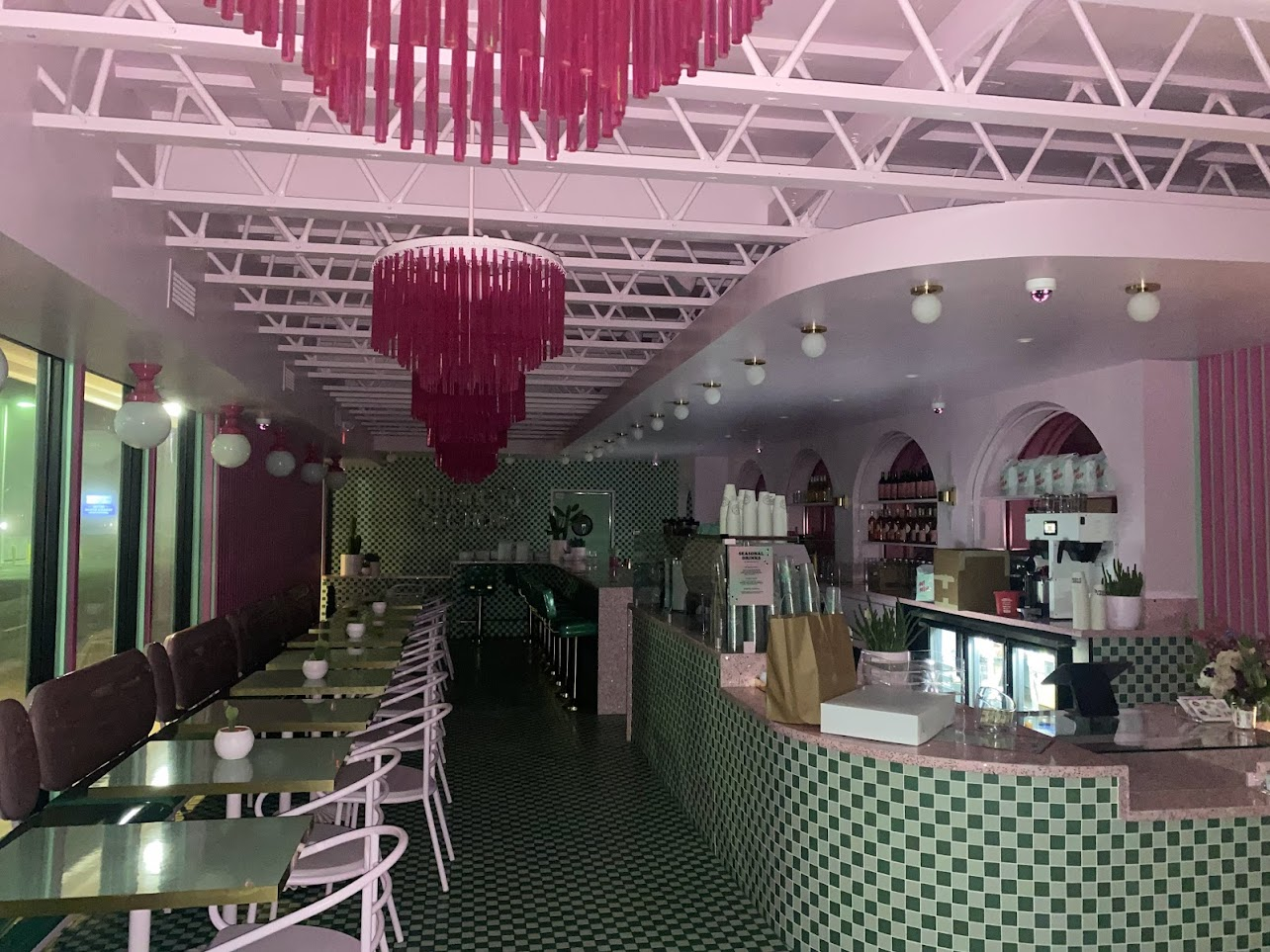 Restaurant with decorative lighting and green tile design